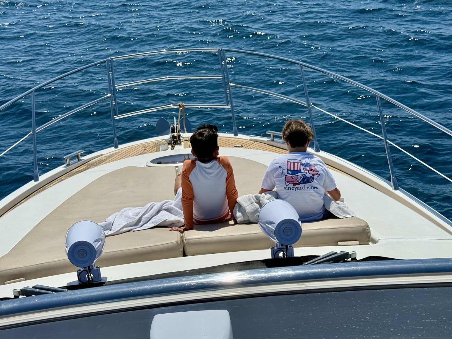 Guests relaxing on the bow of a yacht in Los Cabos